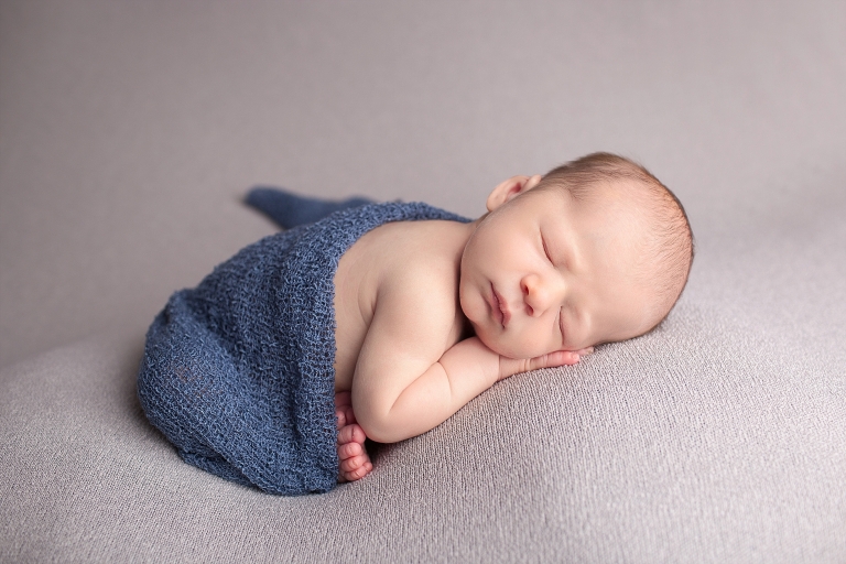 Newborn baby boy in taco position