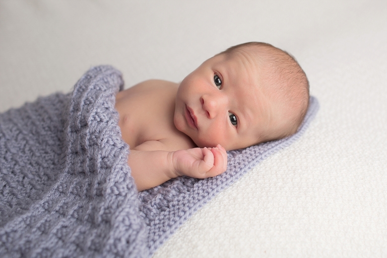 awake baby on heirloom blanket