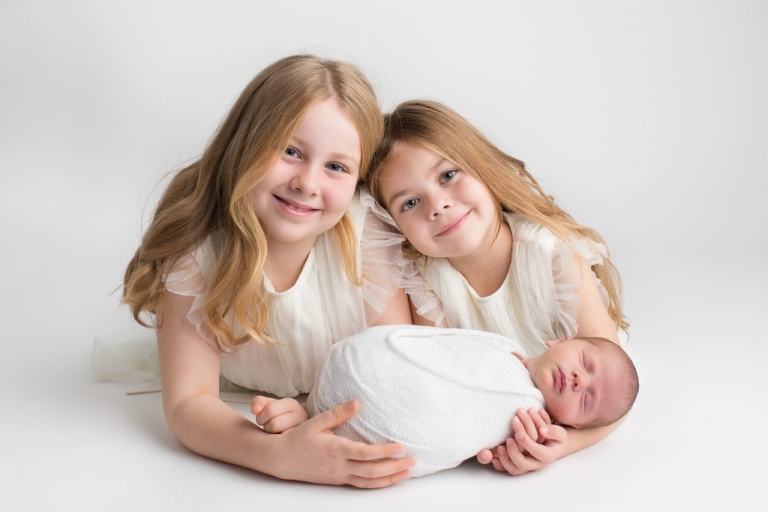 three girls dressed in white